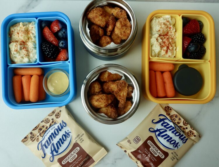 chicken lunchbox with potato salad, berries, carrots and honey mustard.