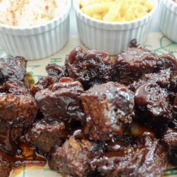 Poor man's burnt ends made with oven-baked chuck roast, coated in sticky barbecue sauce with sides.