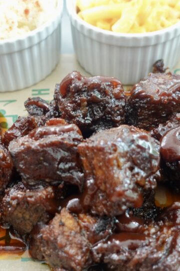 Poor man's burnt ends made with oven-baked chuck roast, coated in sticky barbecue sauce with sides.