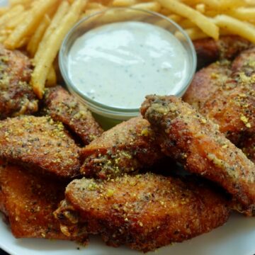 crispy double-fried lemon pepper wings served with ranch dressing and French fries.