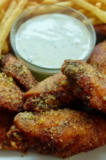 crispy double-fried lemon pepper wings served with ranch dressing and French fries.