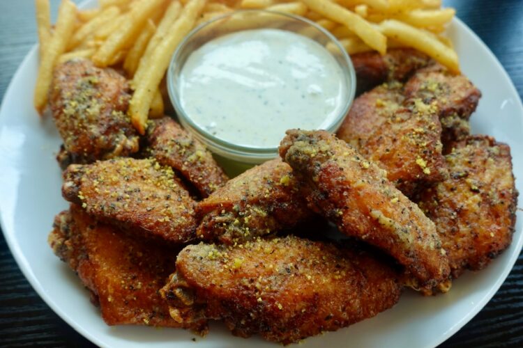 crispy double-fried lemon pepper wings served with ranch dressing and French fries.