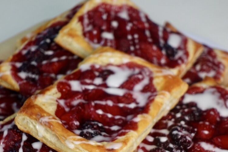 Berry puff pastry filled with homemade strawberry and blackberry compote and drizzled with vanilla glaze.
