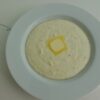 Creamy Southern Grits served with a pat of butter on top.