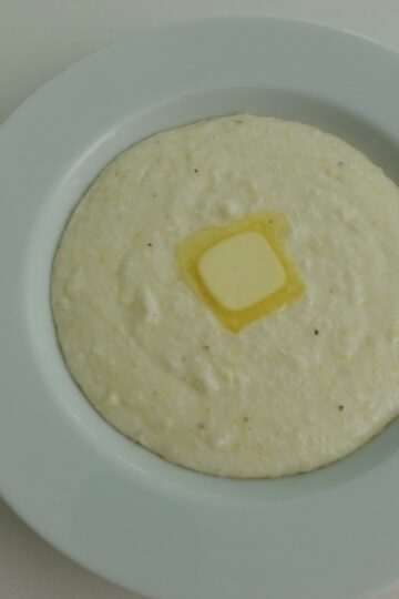 Creamy Southern Grits served with a pat of butter on top.