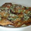 Garlic Parmesan chicken cutlets topped with Parmesan and fresh parsley.