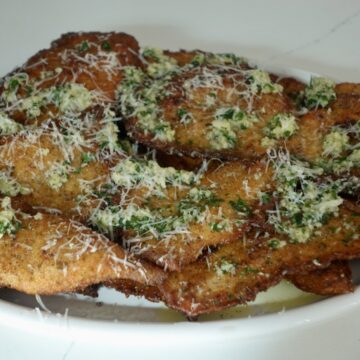 Garlic Parmesan chicken cutlets topped with Parmesan and fresh parsley.