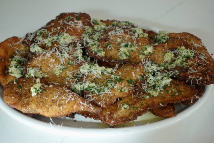 Garlic Parmesan chicken cutlets topped with Parmesan and fresh parsley.