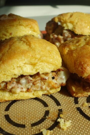 sausage and cheese cornbread biscuit breakfast sandwiches with honey butter glaze