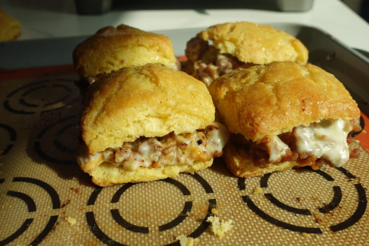 sausage and cheese cornbread biscuit breakfast sandwiches with honey butter glaze