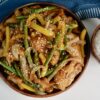 honey sesame chicken breast with green beans and yellow bell peppers served over jasmine rice.