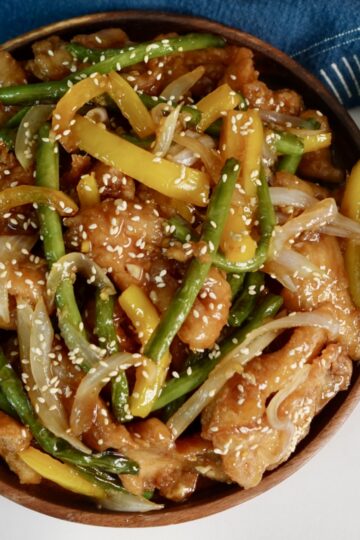 honey sesame chicken breast with green beans and yellow bell peppers served over jasmine rice.