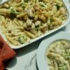 Creamy chicken and broccoli ziti topped with melted mozzarella cheese in a baking dish.