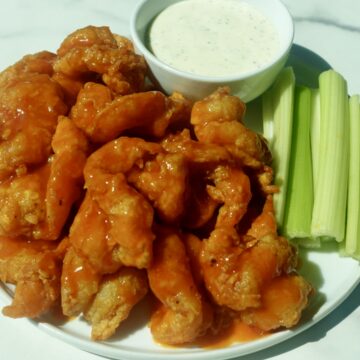 Crispy butterflied fried shrimp coated in spicy buffalo sauce served with creamy ranch dressing and celery sticks.