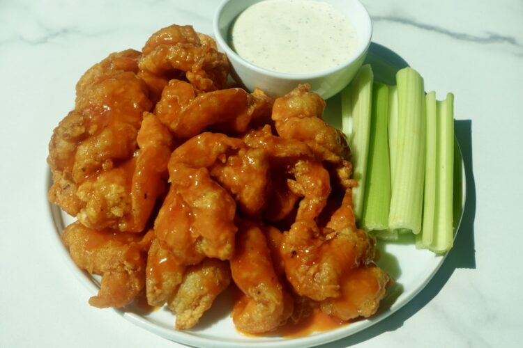 Crispy butterflied fried shrimp coated in spicy buffalo sauce served with creamy ranch dressing and celery sticks.